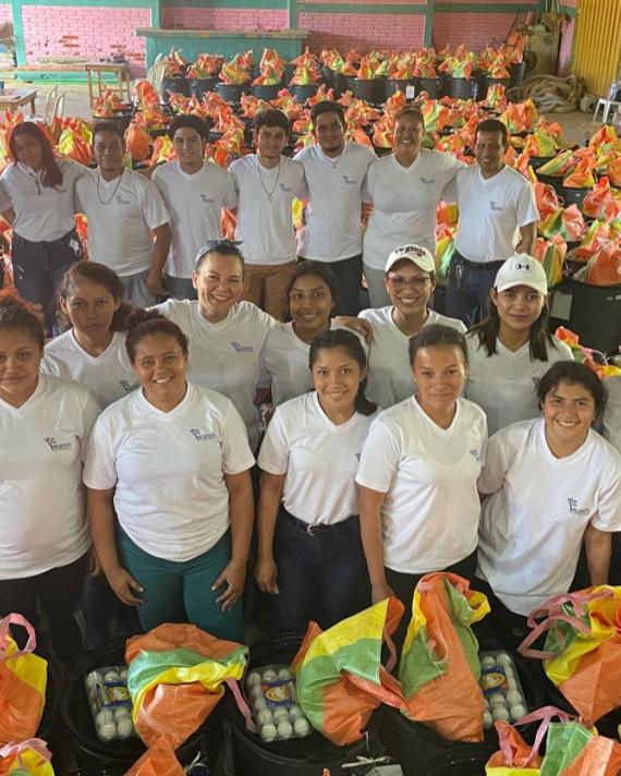 People standing surrounded by gift baskets 