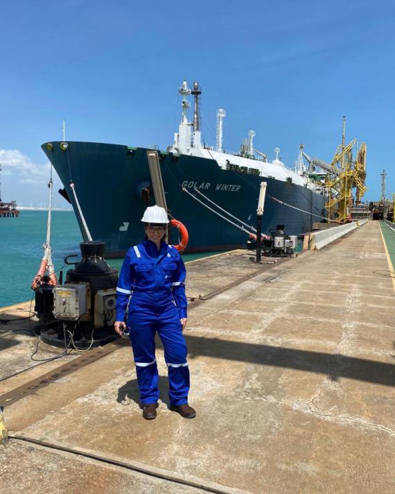 NFE employee standing in front of ship