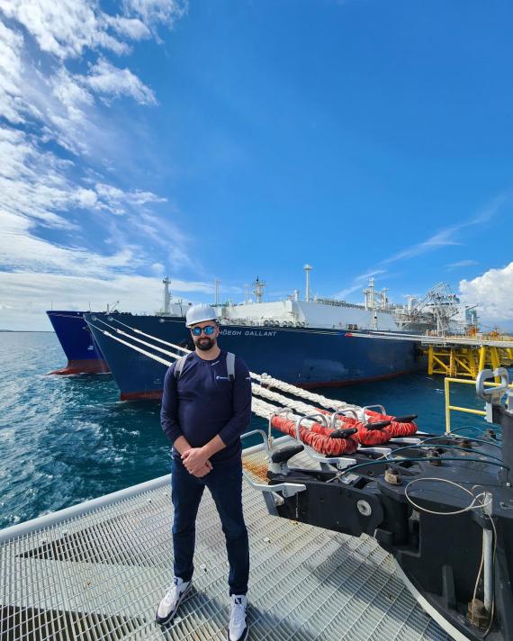 NFE employee standing in front of ship