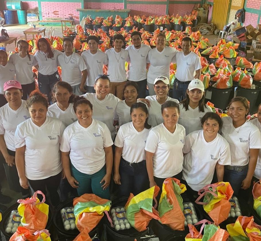 Group of people surrounded by gift baskets 