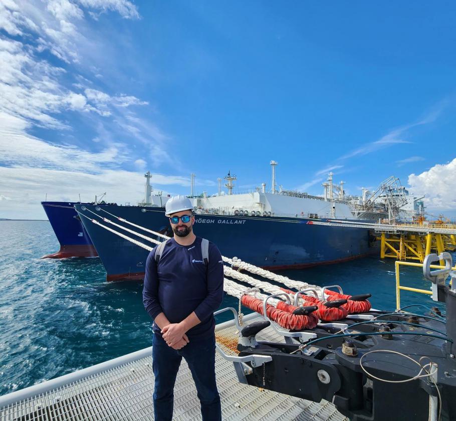 NFE employee standing in front of ship