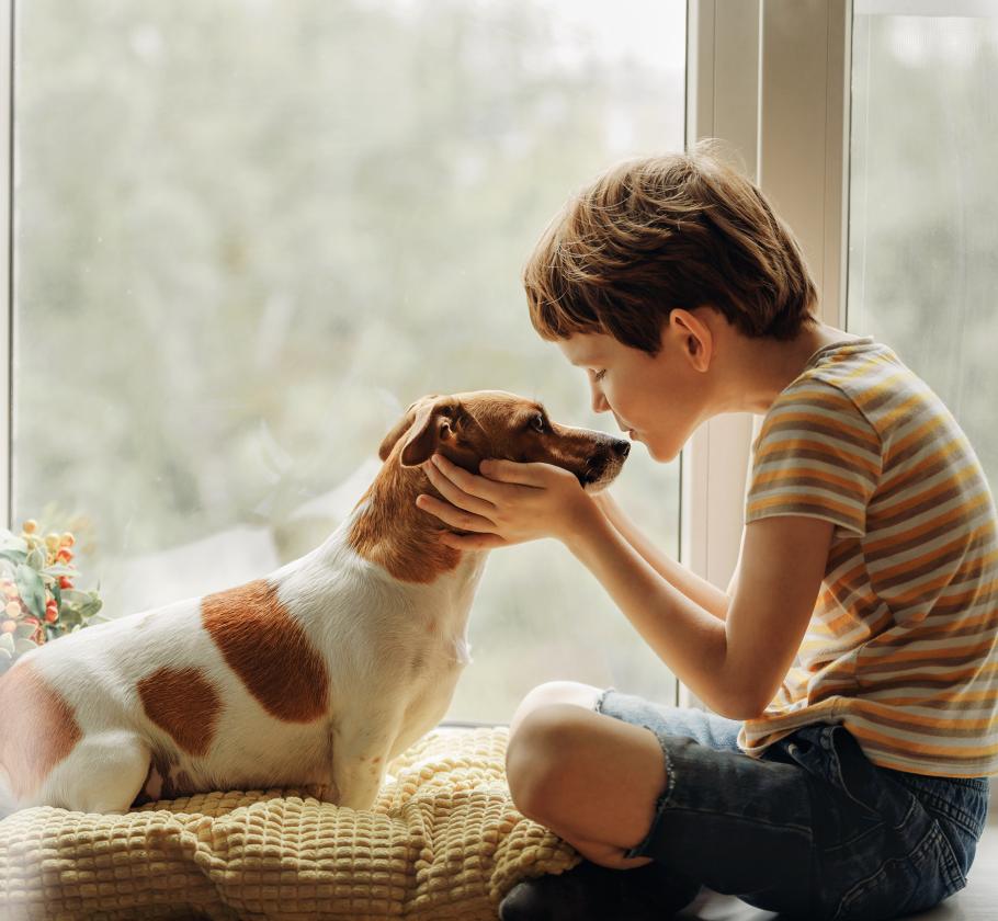 boy kissing a puppy